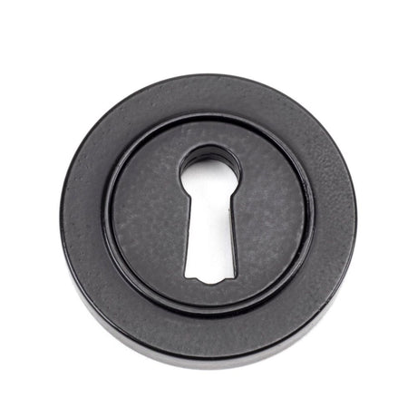 This is an image showing From The Anvil - Matt Black Round Escutcheon (Plain) available from trade door handles, quick delivery and discounted prices