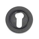 This is an image showing From The Anvil - Matt Black Round Euro Escutcheon (Plain) available from trade door handles, quick delivery and discounted prices