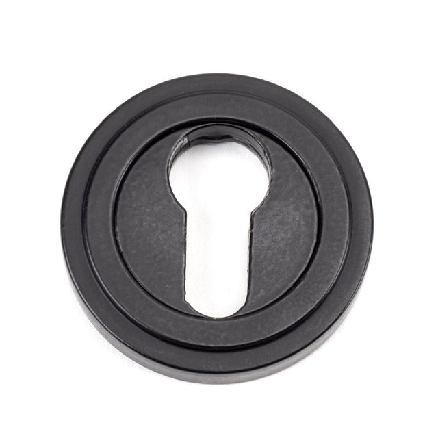 This is an image showing From The Anvil - Matt Black Round Euro Escutcheon (Art Deco) available from trade door handles, quick delivery and discounted prices