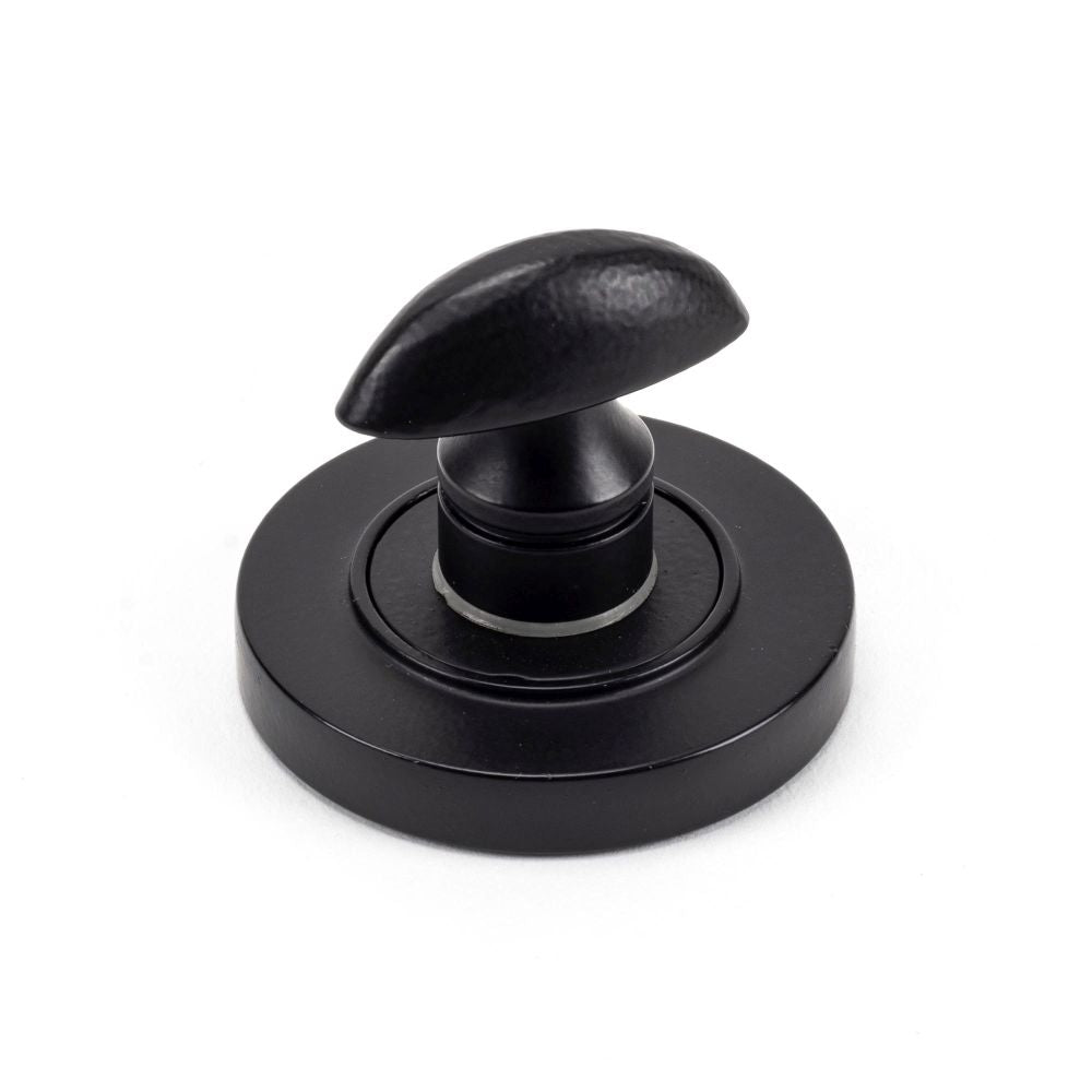 This is an image showing From The Anvil - Matt Black Round Thumbturn Set (Plain) available from trade door handles, quick delivery and discounted prices