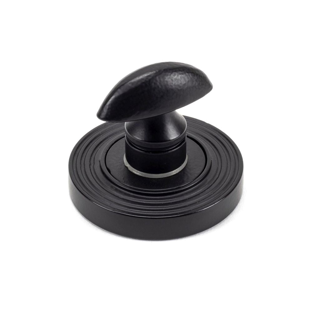 This is an image showing From The Anvil - Matt Black Round Thumbturn Set (Beehive) available from trade door handles, quick delivery and discounted prices