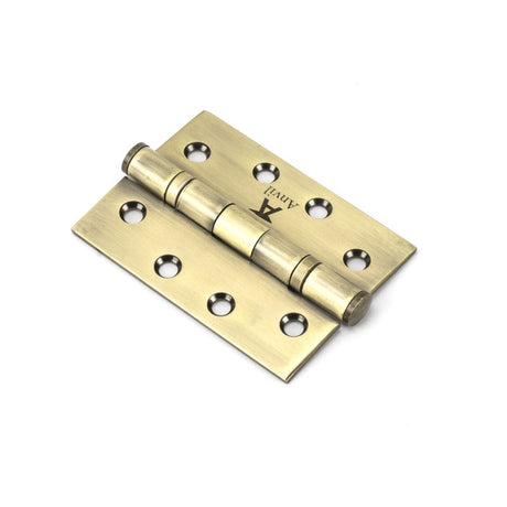 This is an image showing From The Anvil - Aged Brass 4" Ball Bearing Butt Hinge (pair) ss available from trade door handles, quick delivery and discounted prices