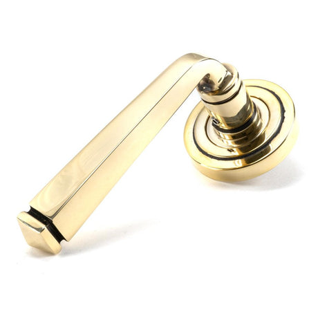 This is an image showing From The Anvil - Aged Brass Avon Round Lever on Rose Set (Art Deco) - Unsprung available from trade door handles, quick delivery and discounted prices