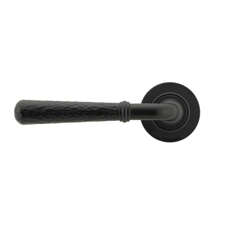 This is an image showing From The Anvil - Matt Black Hammered Newbury Lever on Rose Set (Plain) - Unsprun available from trade door handles, quick delivery and discounted prices