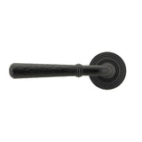 This is an image showing From The Anvil - Matt Black Hammered Newbury Lever on Rose Set (Beehive) - Unspr available from trade door handles, quick delivery and discounted prices