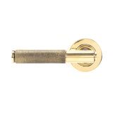 This is an image showing From The Anvil - Aged Brass Brompton Lever on Rose Set (Plain) - Unsprung available from trade door handles, quick delivery and discounted prices