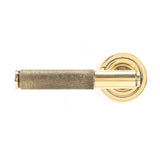 This is an image showing From The Anvil - Aged Brass Brompton Lever on Rose Set (Art Deco) - Unsprung available from trade door handles, quick delivery and discounted prices