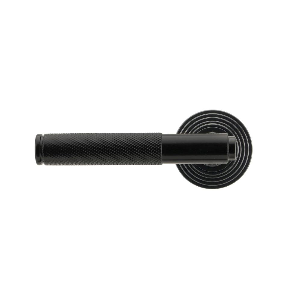 This is an image showing From The Anvil - Black Brompton Lever on Rose Set (Beehive) - Unsprung available from trade door handles, quick delivery and discounted prices