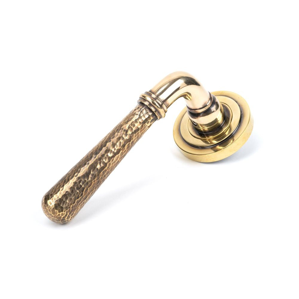 This is an image showing From The Anvil - Aged Brass Hammered Newbury Lever on Rose Set (Art Deco) - Unsp available from trade door handles, quick delivery and discounted prices