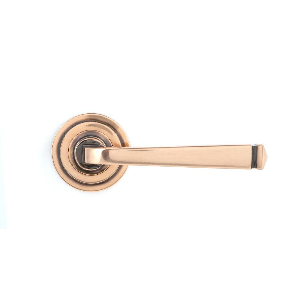 This is an image showing From The Anvil - Polished Bronze Avon Round Lever on Rose Set (Art Deco) - Unspr available from trade door handles, quick delivery and discounted prices