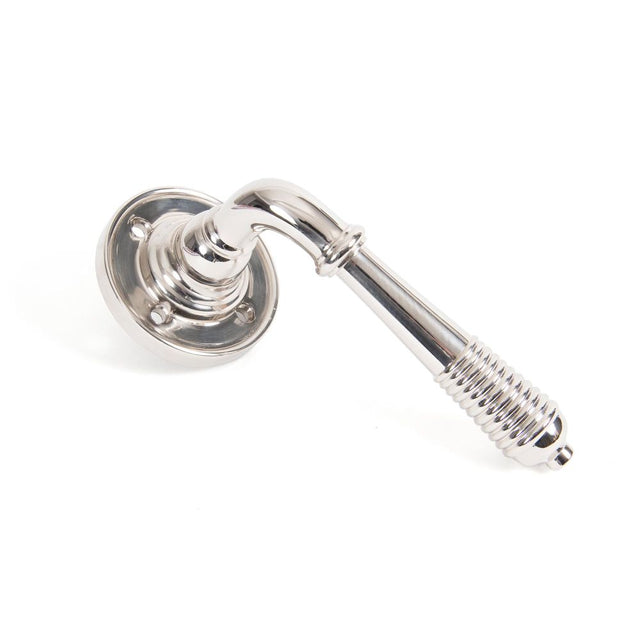 This is an image showing From The Anvil - Polished Nickel Reeded Lever on Rose Set - Unsprung available from trade door handles, quick delivery and discounted prices