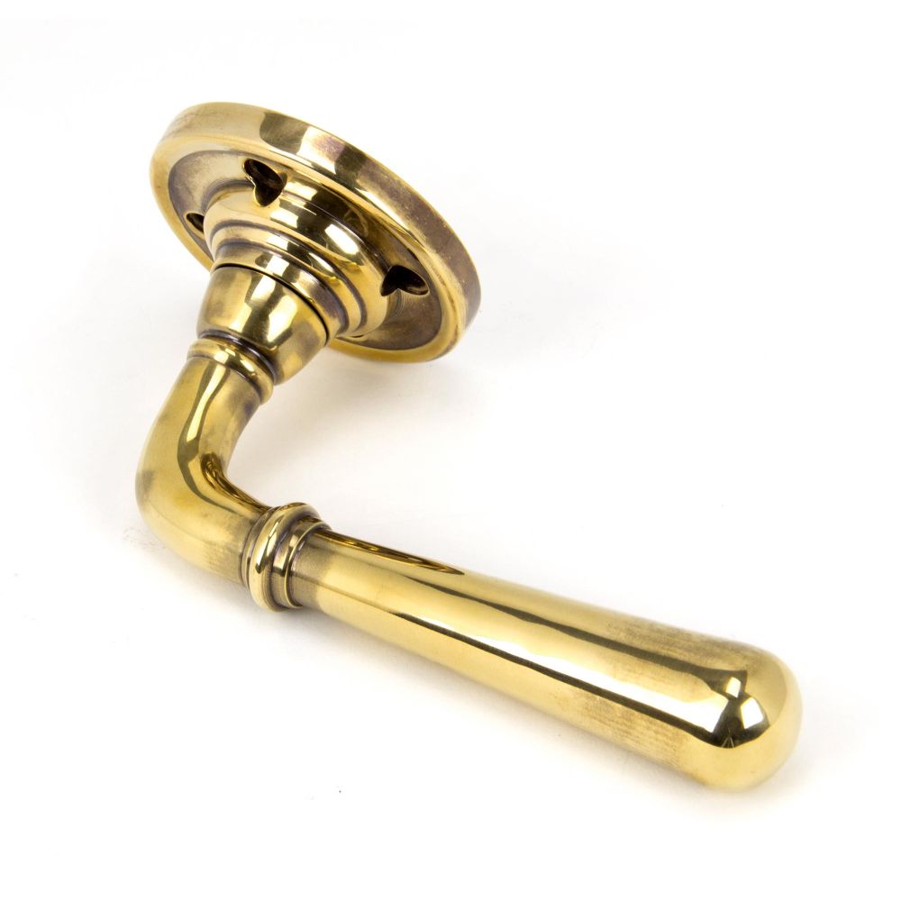 This is an image showing From The Anvil - Aged Brass Newbury Lever on Rose Set - Unsprung available from trade door handles, quick delivery and discounted prices