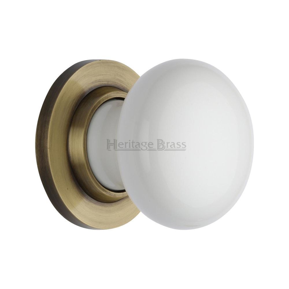 This is an image of a Heritage Brass - White Knob with Antique Brass base, 5010-at that is available to order from Trade Door Handles in Kendal.