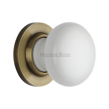 This is an image of a Heritage Brass - White Knob with Antique Brass base, 5010-at that is available to order from Trade Door Handles in Kendal.