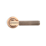 This is an image showing From The Anvil - Polished Bronze Brompton Lever on Rose Set (Plain) - Unsprung available from trade door handles, quick delivery and discounted prices