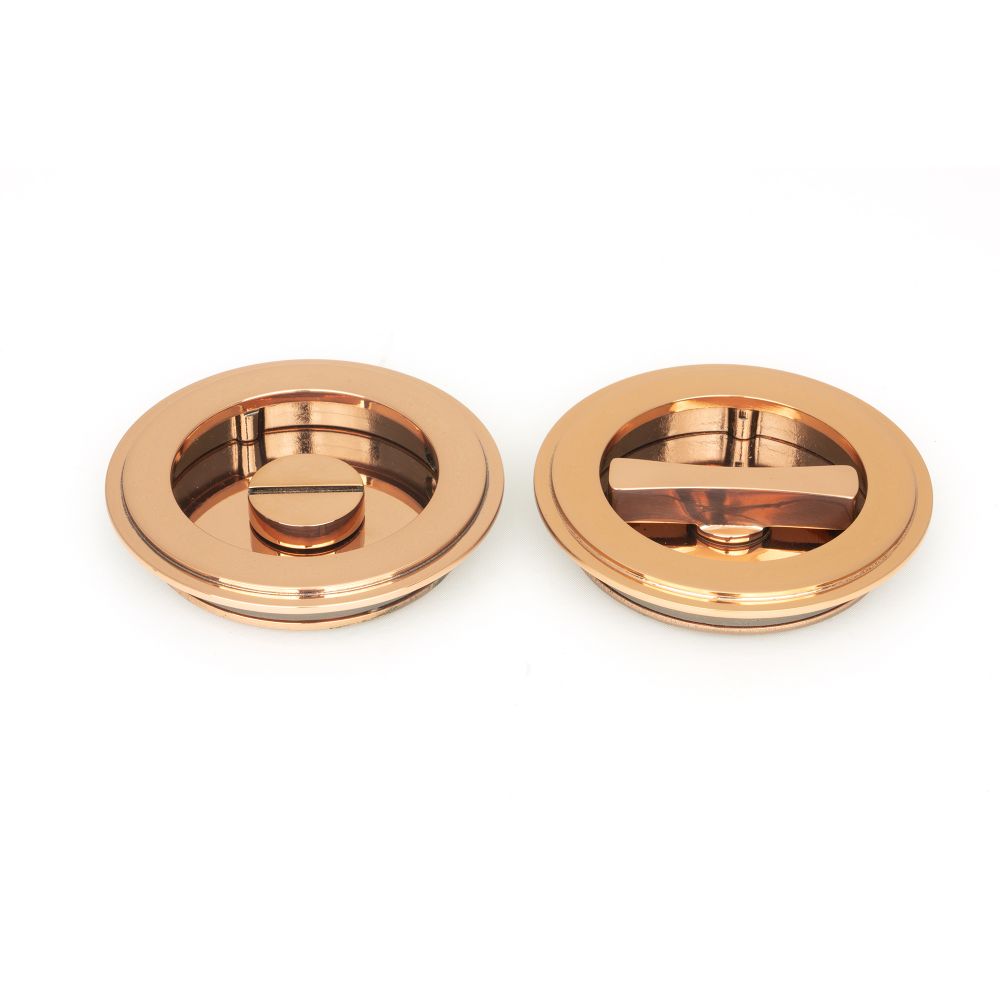 This is an image showing From The Anvil - Polished Bronze 75mm Art Deco Round Pull - Privacy Set available from trade door handles, quick delivery and discounted prices