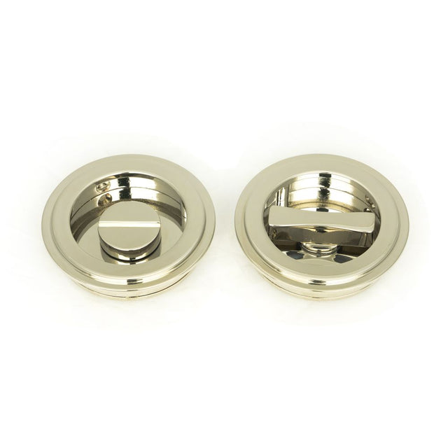 This is an image showing From The Anvil - Polished Nickel 60mm Art Deco Round Pull - Privacy Set available from trade door handles, quick delivery and discounted prices