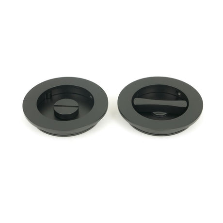 This is an image showing From The Anvil - Matt Black 75mm Plain Round Pull - Privacy Set available from trade door handles, quick delivery and discounted prices