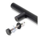 This is an image showing From The Anvil - Matt Black SS (304) 100mm Bolt Fixings for T Bar (2) available from trade door handles, quick delivery and discounted prices