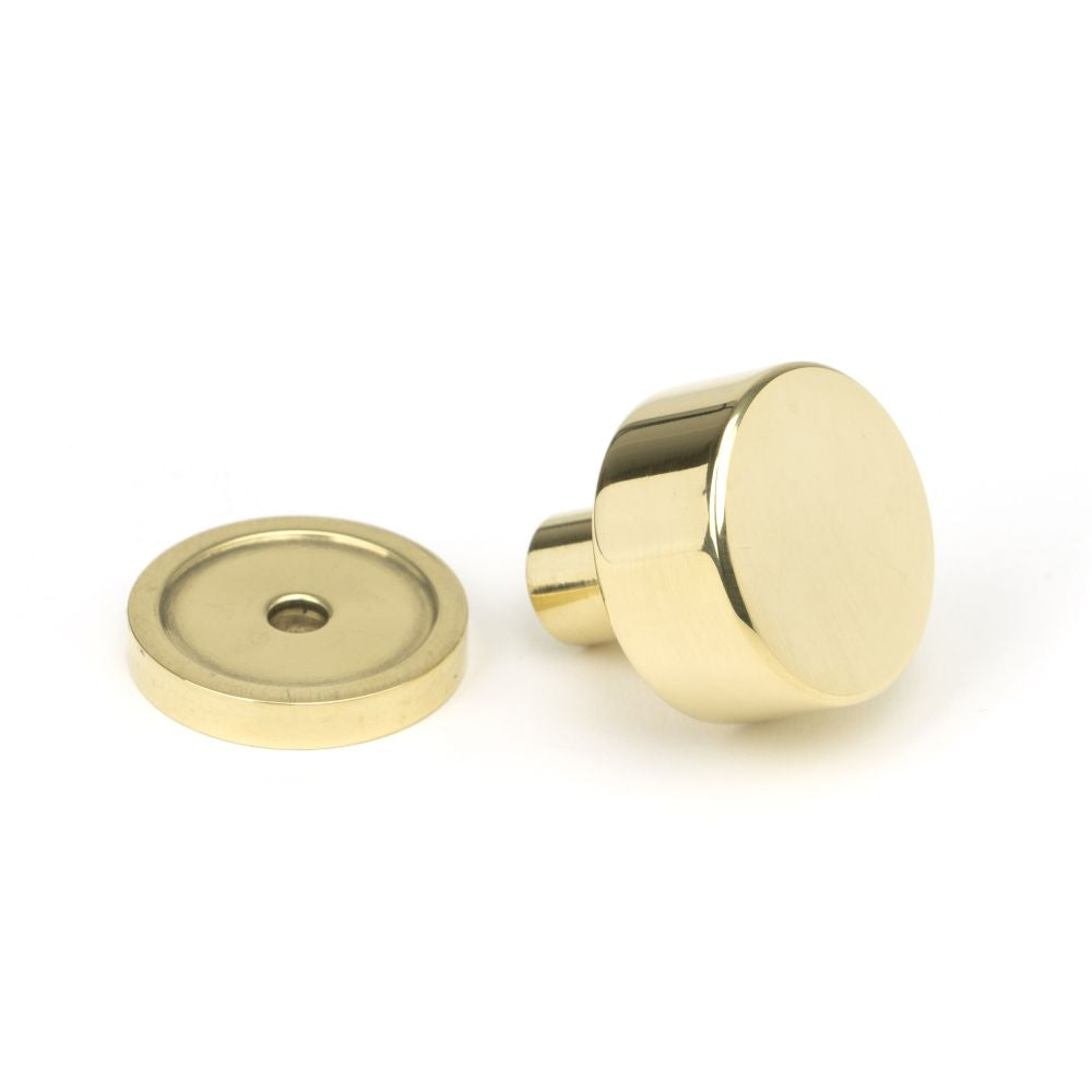 This is an image showing From The Anvil - Polished Brass Kelso Cabinet Knob - 25mm (Plain) available from trade door handles, quick delivery and discounted prices