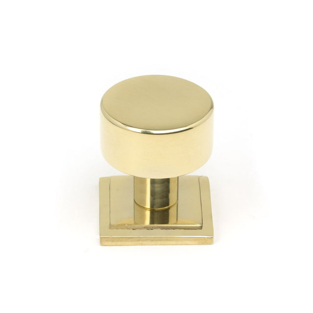 This is an image showing From The Anvil - Polished Brass Kelso Cabinet Knob - 25mm (Square) available from trade door handles, quick delivery and discounted prices