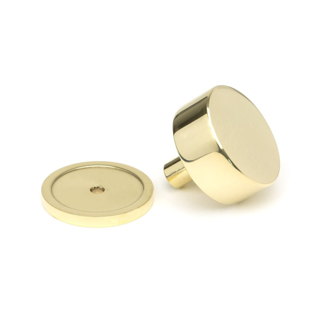 This is an image showing From The Anvil - Polished Brass Kelso Cabinet Knob - 38mm (Plain) available from trade door handles, quick delivery and discounted prices