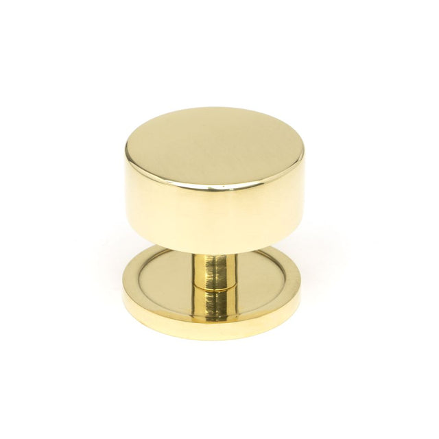 This is an image showing From The Anvil - Polished Brass Kelso Cabinet Knob - 38mm (Plain) available from trade door handles, quick delivery and discounted prices