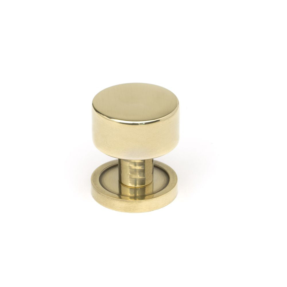 This is an image showing From The Anvil - Aged Brass Kelso Cabinet Knob - 25mm (Plain) available from trade door handles, quick delivery and discounted prices