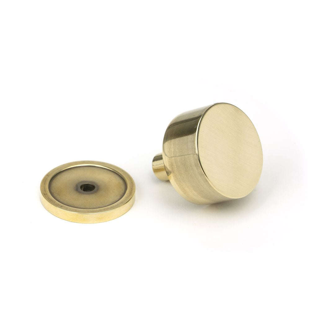 This is an image showing From The Anvil - Aged Brass Kelso Cabinet Knob - 32mm (Plain) available from trade door handles, quick delivery and discounted prices