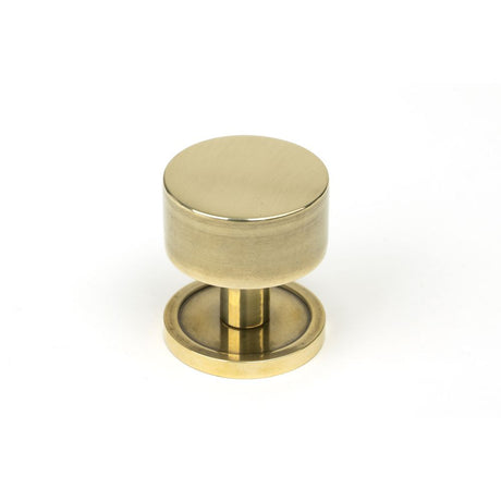 This is an image showing From The Anvil - Aged Brass Kelso Cabinet Knob - 32mm (Plain) available from trade door handles, quick delivery and discounted prices