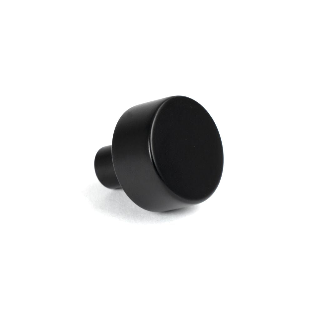 This is an image showing From The Anvil - Matt Black Kelso Cabinet Knob - 25mm (No rose) available from trade door handles, quick delivery and discounted prices