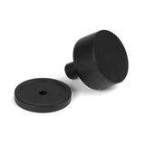 This is an image showing From The Anvil - Matt Black Kelso Cabinet Knob - 32mm (Plain) available from trade door handles, quick delivery and discounted prices