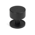 This is an image showing From The Anvil - Matt Black Kelso Cabinet Knob - 32mm (Plain) available from trade door handles, quick delivery and discounted prices