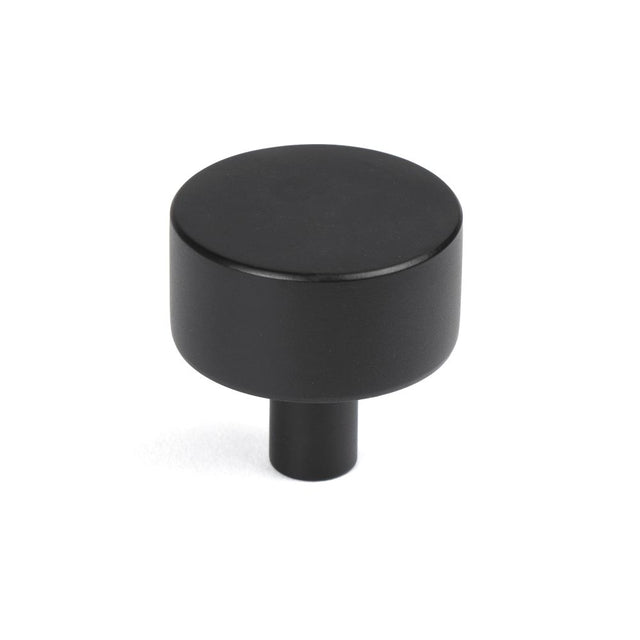 This is an image showing From The Anvil - Matt Black Kelso Cabinet Knob - 32mm (No rose) available from trade door handles, quick delivery and discounted prices