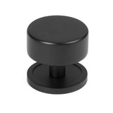 This is an image showing From The Anvil - Matt Black Kelso Cabinet Knob - 38mm (Plain) available from trade door handles, quick delivery and discounted prices