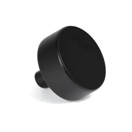 This is an image showing From The Anvil - Matt Black Kelso Cabinet Knob - 38mm (No rose) available from trade door handles, quick delivery and discounted prices