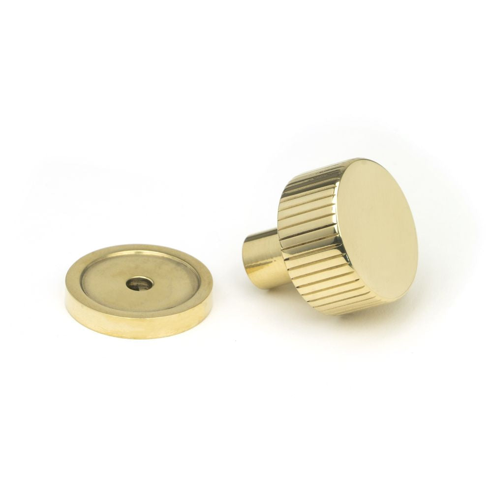 This is an image showing From The Anvil - Polished Brass Judd Cabinet Knob - 25mm (Plain) available from trade door handles, quick delivery and discounted prices