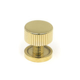 This is an image showing From The Anvil - Polished Brass Judd Cabinet Knob - 25mm (Plain) available from trade door handles, quick delivery and discounted prices