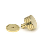 This is an image showing From The Anvil - Polished Brass Judd Cabinet Knob - 32mm (Plain) available from trade door handles, quick delivery and discounted prices