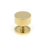 This is an image showing From The Anvil - Polished Brass Judd Cabinet Knob - 32mm (Plain) available from trade door handles, quick delivery and discounted prices