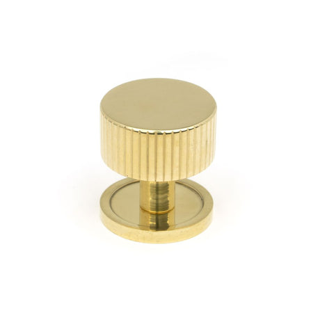 This is an image showing From The Anvil - Polished Brass Judd Cabinet Knob - 32mm (Plain) available from trade door handles, quick delivery and discounted prices