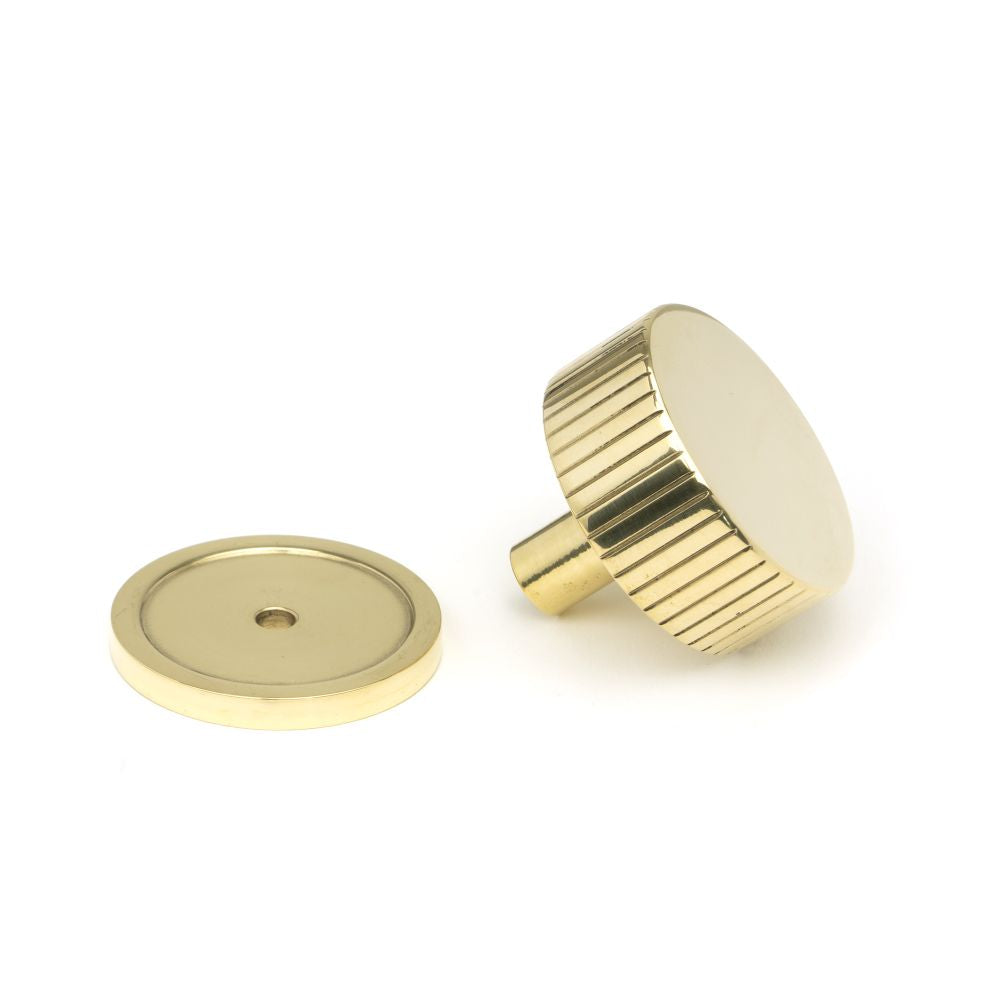 This is an image showing From The Anvil - Polished Brass Judd Cabinet Knob - 38mm (Plain) available from trade door handles, quick delivery and discounted prices