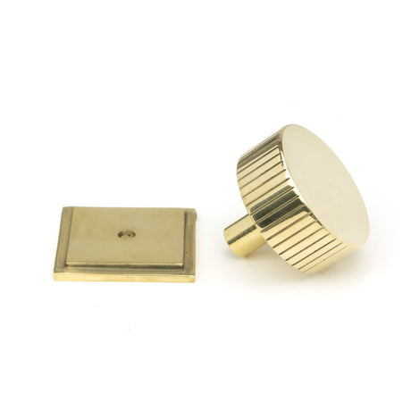 This is an image showing From The Anvil - Polished Brass Judd Cabinet Knob - 38mm (Square) available from trade door handles, quick delivery and discounted prices