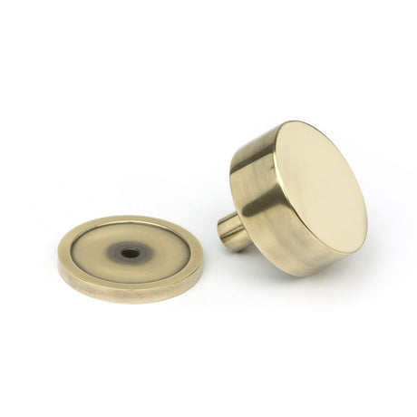 This is an image showing From The Anvil - Aged Brass Kelso Cabinet Knob - 38mm (Plain) available from trade door handles, quick delivery and discounted prices