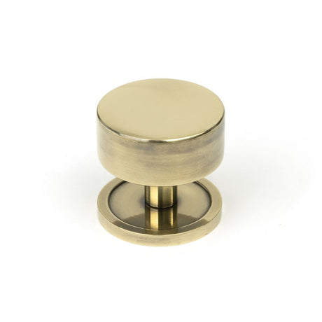 This is an image showing From The Anvil - Aged Brass Kelso Cabinet Knob - 38mm (Plain) available from trade door handles, quick delivery and discounted prices