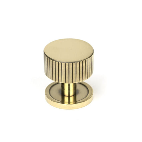 This is an image showing From The Anvil - Aged Brass Judd Cabinet Knob - 32mm (Plain) available from trade door handles, quick delivery and discounted prices