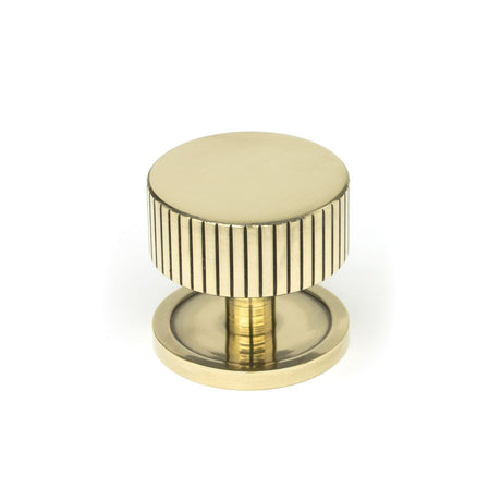 This is an image showing From The Anvil - Aged Brass Judd Cabinet Knob - 38mm (Plain) available from trade door handles, quick delivery and discounted prices