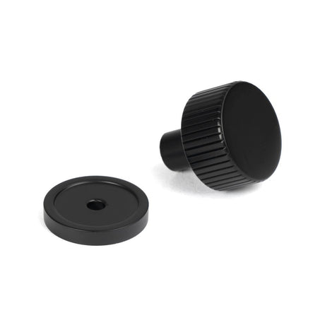 This is an image showing From The Anvil - Matt Black Judd Cabinet Knob - 25mm (Plain) available from trade door handles, quick delivery and discounted prices