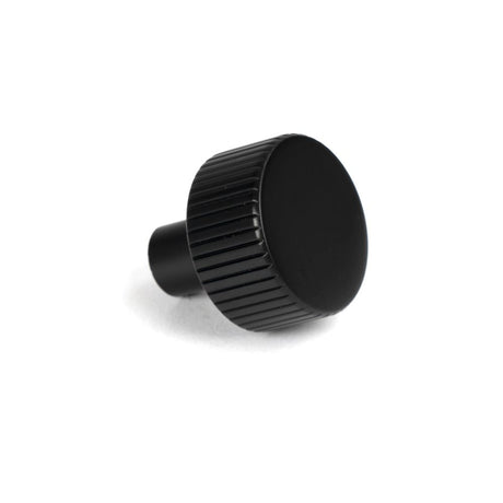 This is an image showing From The Anvil - Matt Black Judd Cabinet Knob - 25mm (No rose) available from trade door handles, quick delivery and discounted prices