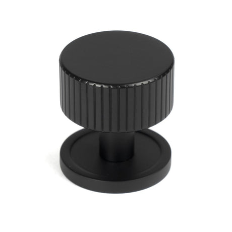 This is an image showing From The Anvil - Matt Black Judd Cabinet Knob - 32mm (Plain) available from trade door handles, quick delivery and discounted prices